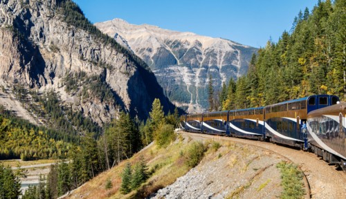 The Rocky Mountaineer railway train winds it's way through Banff National Park in Alberta, Canada.