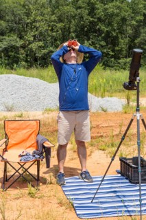 A photographer with solar binoculars observes the Great American Eclipse on August 21, 2017.