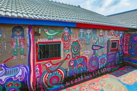 TAICHUNG, TAIWAN - JULY 19: Rainbow village is a popular travel destination where people can view colorful paintings and illustrations on the walls of