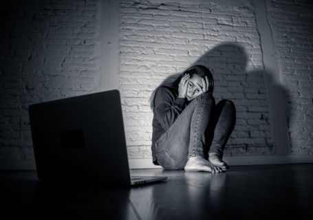 Woman suffering Internet cyber bullying