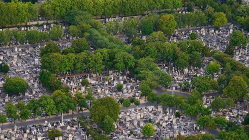 Closeup aerial view of Montparnasse Cemetery (Cimetiere du Montparnasse), second-largest cemetery in Paris, France, with large number of tombstones.