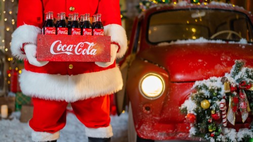 06.11.2020 Russia, Novosibirsk: Portrait of Santa Claus holding a package of Coca Cola bottles. Christmas greeting card