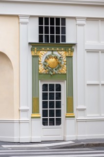 Paris, an ancient door, beautiful decorated facade in the Opera district