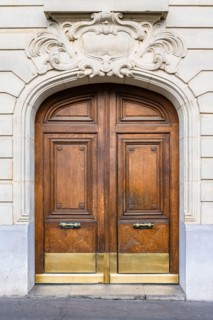 Paris, an ancient wooden door, beautiful facade in the 11e arrondissement