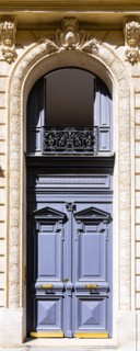 Paris, an ancient wooden door, typical building in the 11e arrondissement