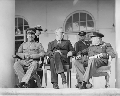 Joseph Stalin, Franklin D. Roosevelt and Winston Churchill on the veranda of the Soviet Legation in Teheran, during the first “Big Three” Conference, November 1943. In the background are aides to the ...