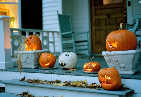 Halloween pumpkins glowing on a porch in Sharon, Connecticut, New England, USA.