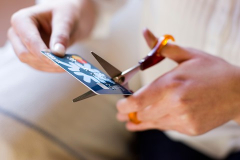 Woman cutting up credit card