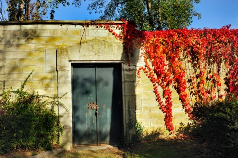 Paris, France - Detail, Pere Lachaise Cemetery, Locked Door on Garden Wall in Autumn