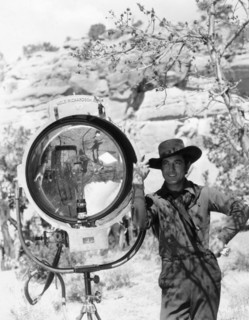 JOHNNY MACK BROWN publicity pose on set location candid next to Mole-Richardson movie light during location filming of  BILLY THE KID 1930 director KING VIDOR book Walter Noble Burns dialogue Laurence...