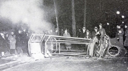 Black and white photo of a scene from the demonstrations of 6 February 1934. A bus has been stopped by demonstrators