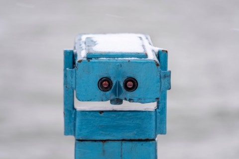 Old coin operated telescope on the seafront in Southend on Sea, Essex, UK, with snow from Storm Darcy. Looks like a face