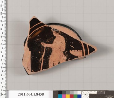 Terracotta fragment of a stemless kylix (drinking cup) 460–450 B.C. Greek, Attic Interior, wreathed youth to left, with his himation draped over his right shoulder and around his right arm, holding a ...