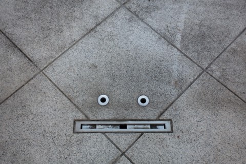 Details in a floor resemble a face in an example of pareidolia. Tokyo, Japan.