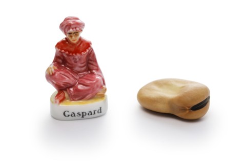 small porcelain doll and broad bean to hide in Roscón de Reyes (Spanish King’s cake).