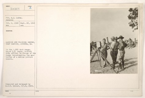 Major R.S. Mayne, a British Army officer, is seen investigating a motion picture camera at the Machine Gun Training Center in Camp Hancock, Augusta, Georgia. This image documents the military's intere...