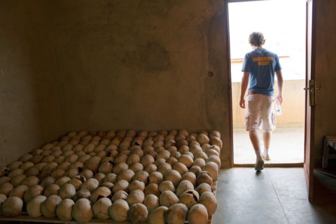 An English public schoolboy leaves a room full of skulls of victims from the 1994 Rwandan genocide .