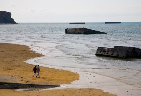 The Beach at Arromanches, Normandy with some of the remains of the Mulberry Harbour used in the 1944 Normandy Landings