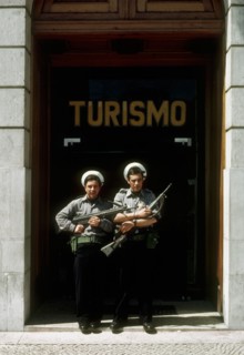 Portuguese marines stand guard outside the tourism office in Lisbon, with flowers in their guns, following the 'Carnation Revolution, the bloodless military coup of 25 April 1974 which deposed the aut...