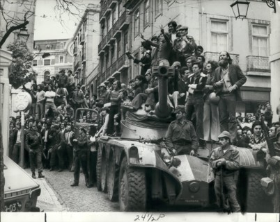 May 05, 1974 - The military uprising in Portugal.: Photo shows Jubilant Portuguese clamber aboard the armoured cars in Lisbon following the army take over in Portugal.
