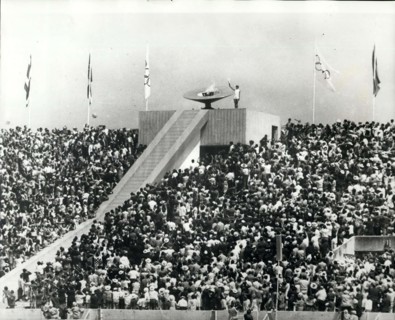 1968 - Opening of the Olympic Games Lighting the Flame: Photo Shows 20-year old Mexican athlete Enriqueta Basilio, is seen lighting the Olympic Flame Torch - the first woman in the history of modern O...