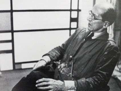 Photograph of the famous Dutch artist Piet Mondrian (7th March 1872 - 1st February 1944). He is shown seated infront of one of his pieces of work. The photograph was taken around 1942.