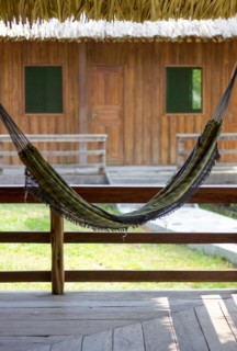 Hammock hanging with a house with two windows at the background and creating a pareidolia of a smiley face