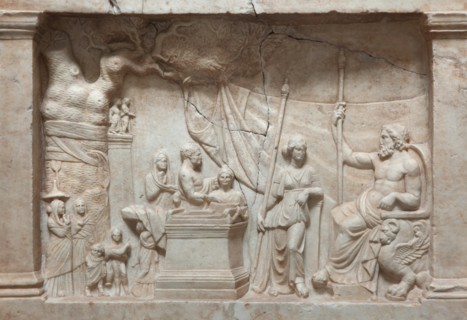Munich Votive Relief. Greek votive relief from about 220 BC on display in the Glyptothek Museum in Munich, Bavaria, Germany. In a rural sanctuary a sacrificing family approach Asclepius, the god of he...