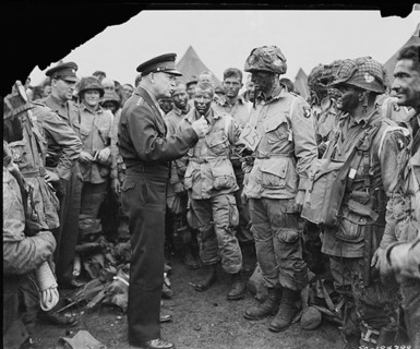 General Dwight D. Eisenhower gives the order of the Day.  "Full victory-nothing else" to paratroopers in England, just before they board their airplanes to participate in the first assault in the inva...