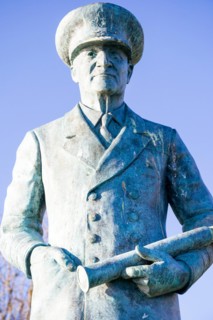 Close up, statue of Vice Admiral Ramsay on the cliff top at Dover castle.Standing with one hand in pocket and the other holding a telescope. Blue sky.