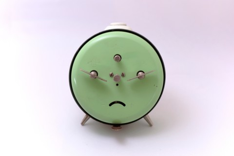An old Junghans mechanical alarm clock with a white background