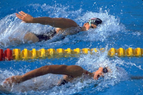 Barcelona, Spain, 1992: Team USA swimmer Nicole Haislett, top, competing in freestyle event at the 1992 Summer Olympics. ©Bob Daemmrich