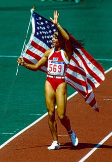 Florence Griffith Joyner (USA) celebrates with the American Flag after winning the gold medal in the Women's 100m Final at the 1988 Olympic Summer Games.