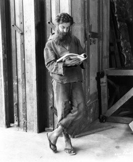 ROBERT DONAT on set candid reading his script during break in filming of THE COUNT OF MONTE CRISTO 1934 director ROWLAND V. LEE novel Alexandre Dumas screenplay Philip Dunne Dan Totheroh  and Rowland ...