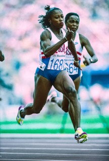 Gail Devers (USA) #1687 and Evelyn Ashford (USA) competing in the semi-finals of the Women's 100 meters at the 1992 Olympic Summer Games.
