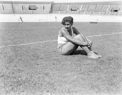 Female athlete sitting on the lawn in the Olympic Stadium ca. 1932