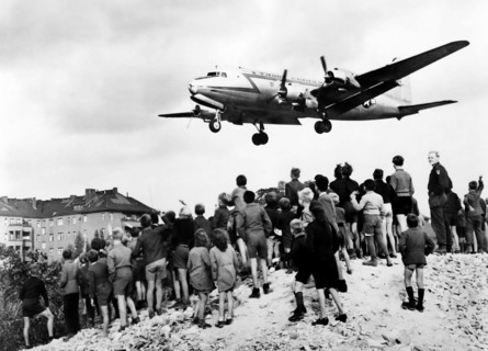 Berlin Airlift. West Berliners watch a Douglas C-54 Skymaster land at Tempelhof Airport in 1948, during the Berlin Blockade (24 June 1948 – 12 May 1949)