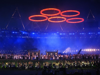 Some of the cast for the final rehearsal for the opening ceremony of the 30th Olympic Games under Olympic Rings