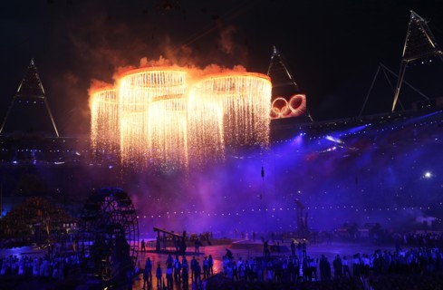 Artists perform as the Olympic rings are seen over the stadium during the Opening Ceremony of the London 2012 Olympic Games, London, Britain, 27 July 2012. The 2012 Summer Olympic Games will be held i...