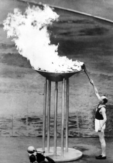 Paavo Nurmi lights the torch at the opening ceremony