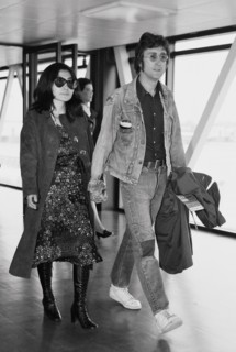 Former Beatle John Lennon with his wife Yoko Ono leaving Heathrow Airport for the Cannes Film festival where two of their films "The Fly" and "Apotheosis" are being shown. 14th May 1971.