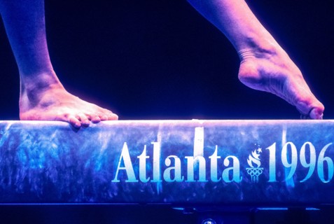 Detail of female gymnast preforming on the balance beam