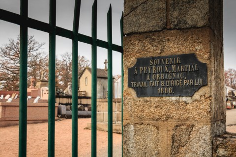 ORADOUR SUR GLANE, FRANCE - December 03, 2017 : commemorative plaque at the entrance of the cemetery where it is written in French - souvenir to PEYRO
