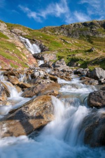 Alpine waterfall on the GR Tour du Mont-Blanc trail to the Robert Blanc refuge, Savoie (73), Auvergne-Rhone-Alpes, France