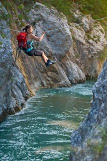 Woman crossing river on Tyrolean traverse  in the Verdon canyon