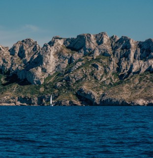 Steep rocky cliffs above a serene sea in The Calanques, Marseille