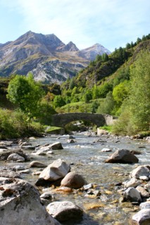 Bridge over stream Gavarnie foothills of Pyrenees France