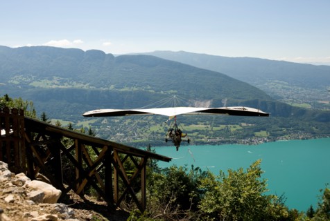 hang glider taking off from a ramp at the col de la forclaz above lake annecy haute savoie france