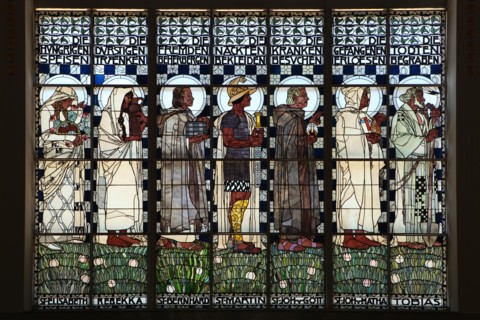 Stained glass window 'The Seven Corporal Works of Mercy' designed by Austrian artist Koloman Moser (1907) in the Steinhof Church (Kirche am Steinhof) in Vienna, Austria. Saints and Old Testaments char...