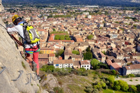 climber on rock wall, town Cavaillon in background, via ferrata de Cavaillon, France, Provence, Cavaillon